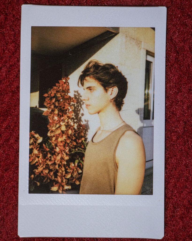 Polaroid side profile of Pedro Flynn at golden hour