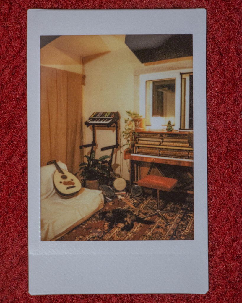 Polaroid of a music studio with an Oud and piano