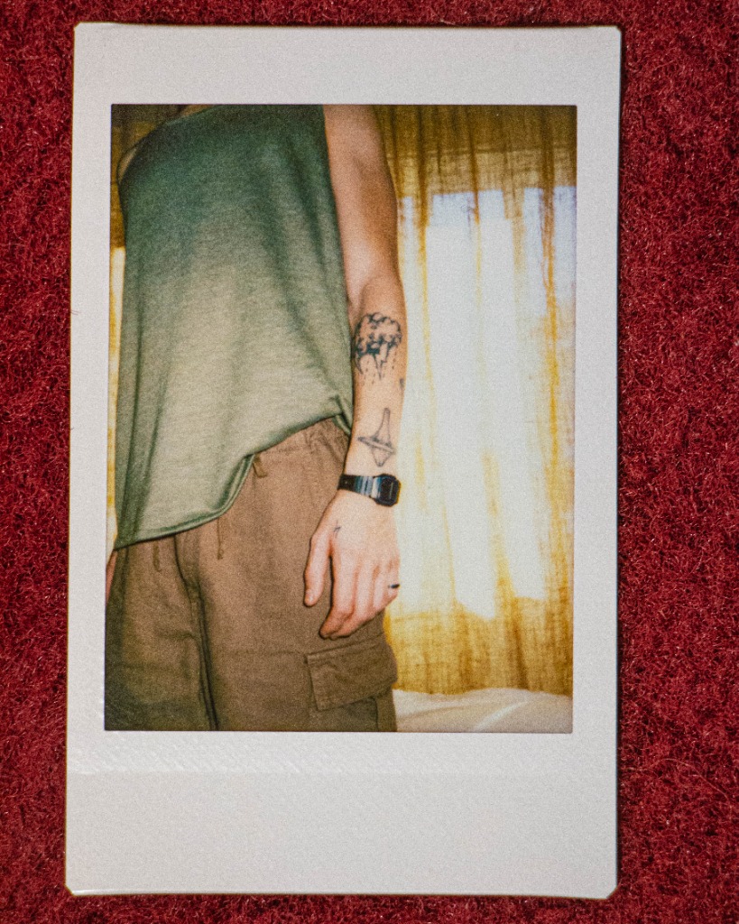 Polaroid of Flynn's clothing and tattoos